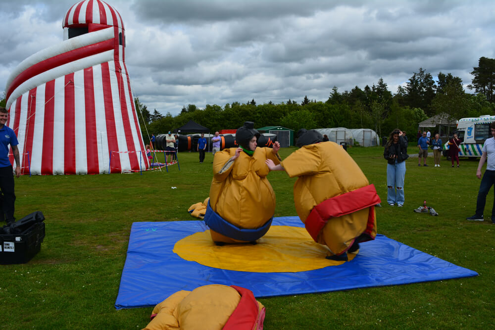 Iain Dunn and a colleague wrestling in sumo suits